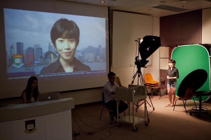 Student presenting in front of green screen