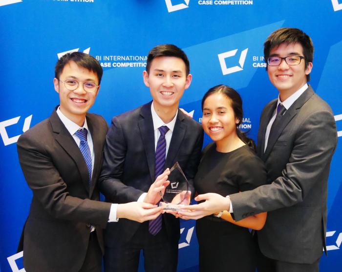 Group of students at Bi International case competition holding an award