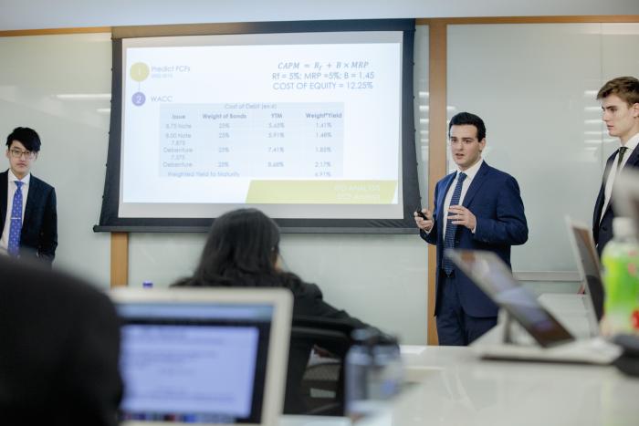 Group of students wearing formal attire presenting in class