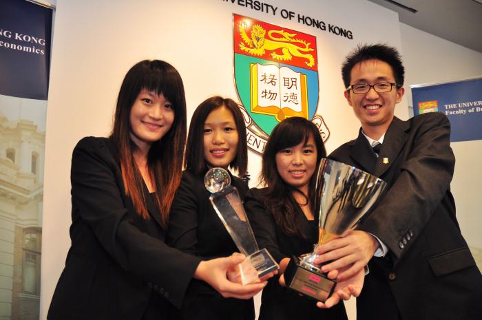 Business students holding awards