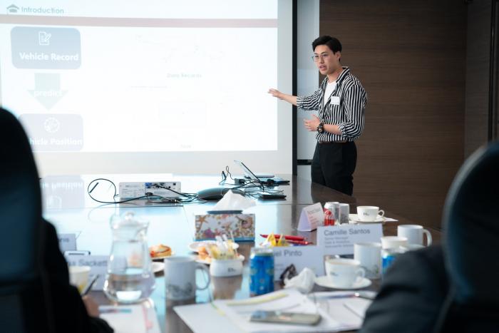 Student presenting in meeting room