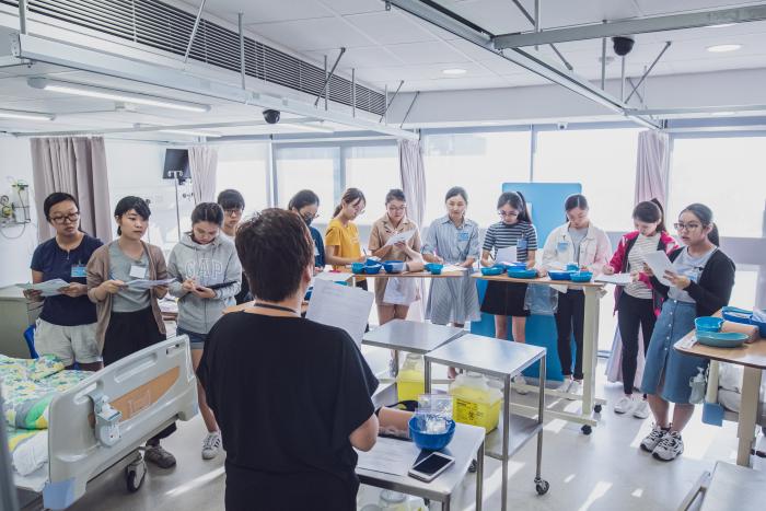 Students listening to professor at a medical simulation training centre