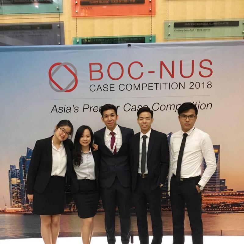 Students wearing formal attire standing in front of  banner for BOC-NUS Case Competition 2018