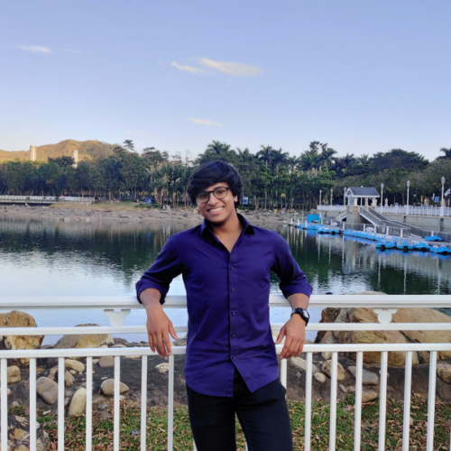 A boy standing in front of a river